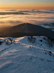 Aerial sunrise view over winter mountains.
