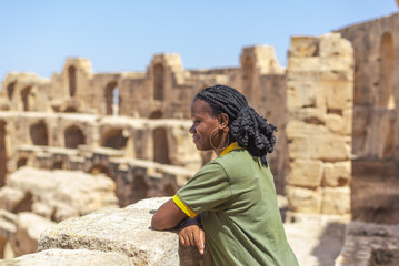 Young Woman in Ancient Ruins in Sunligh