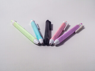Collection of ballpoint pens in pastel colors isolated on a white background