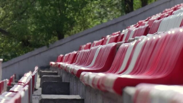 Air shimmer and heat haze above empty stadium with rows of seats in extreme heat. Video is distorted by extreme heat and hot air rising from sun-scorched concrete, creating wavy and shimmering effect