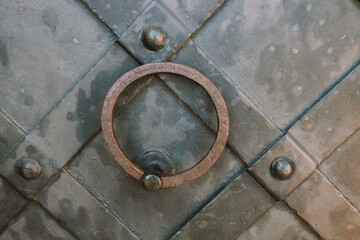 Metal door handle, old, historical on blue door. High quality photo