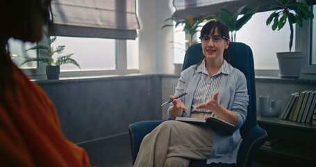 Beginning of psychotherapy: female psychotherapist starts therapy with African American teenager....