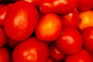 A bright cluster of fresh ripe red tomatoes close-up