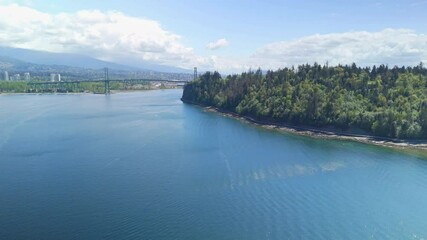 Aerial view of Stanley Park in Vancouver shore with the city and sea
