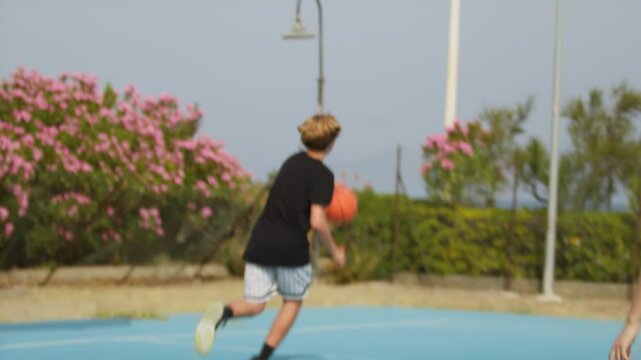 Boy Trying Three Point Shot On Basketball Court