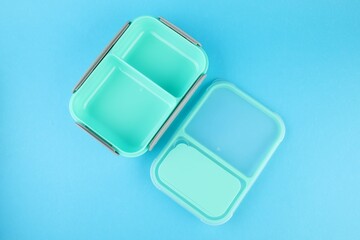 Empty plastic lunch box on light blue background