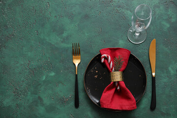Festive table setting with Christmas decorations on green table