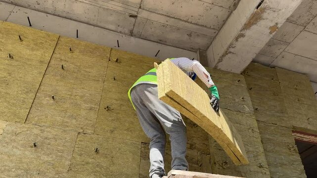 Installation of insulation on the facade of a building, live footage