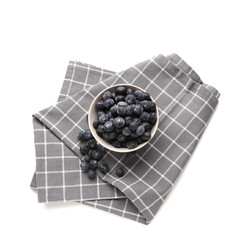 Bowl with tasty blueberry and napkin isolated on white background