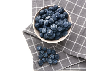 Bowl with tasty blueberry and napkin isolated on white background