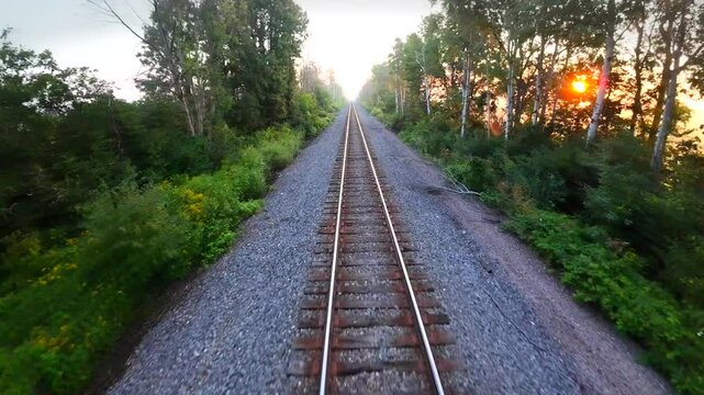 Rolling down rural train tracks amid Misty sunrise.
