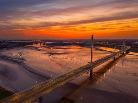 Liverpool, Merseyside, UK, September 18, 2024; aerial view of the Mersey Gateway toll bridge with stunning sun set over the River Mersey, Liverpool, UK.
