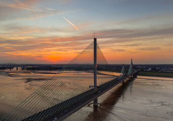 Liverpool, Merseyside, UK, September 18, 2024; aerial view of the Mersey Gateway toll bridge with stunning sun set over the River Mersey, Liverpool, UK.