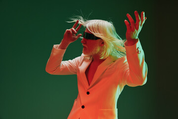 Stylish performer with long white hair, wearing a blindfold, posing dramatically in an artistic...