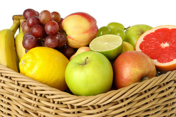 Many different fresh fruits in wicker basket isolated on white