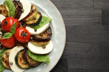 Tasty salad with grilled vegetables and mozzarella cheese on wooden table, top view. Space for text