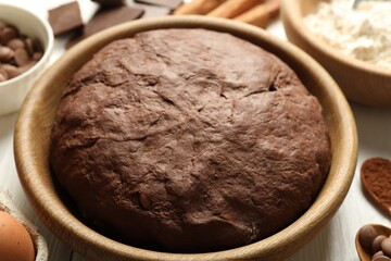 Chocolate dough and ingredients on white wooden table, closeup