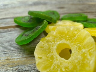 pineapple and kiwi slices on a wooden table. High quality photo