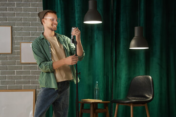 Male standup comedian with microphone performing on stage