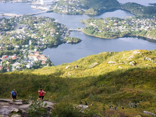 People climbing the Floya mountain with a great view of Svolvaer town in the background.  © TOMASZ