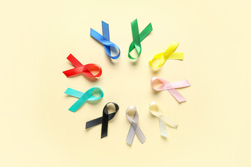 Frame made from colorful ribbons on yellow background. World Cancer Day