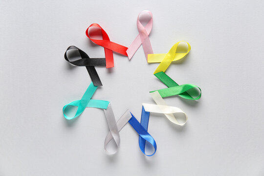 Frame made from colorful ribbons on grey background. World Cancer Day