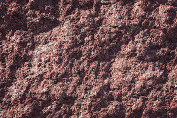 Texture of natural stone surface with relief shadow, background.