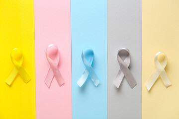 Colorful ribbons on color background. World Cancer Day