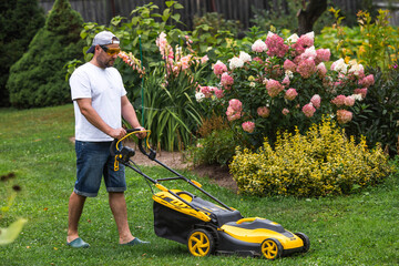 The banner. A lawn mower man mows the grass in the backyard. Agricultural machinery for garden...