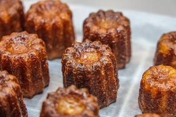 caneles de bordeaux. canelé is a small french pastry flavored with rum and vanilla with a soft and tender custard center and a dark, thick caramelized crust.