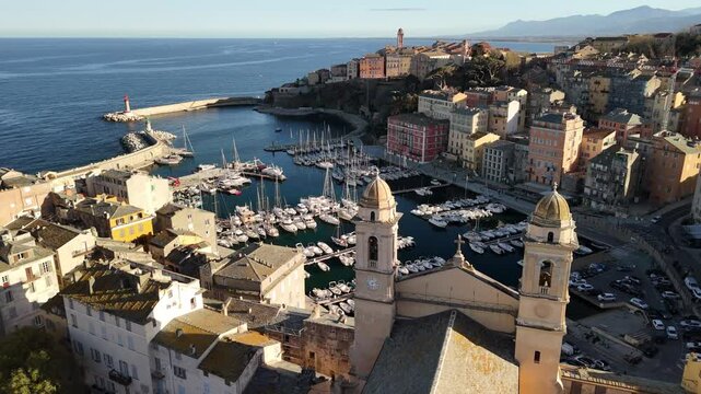 Discover the stunning marina and vibrant architecture of Bastia, Corsica during golden hour