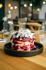 Appetizing pancakes with fresh berries and jam close-up.