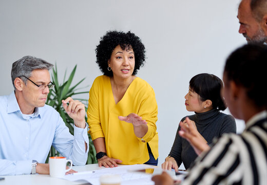 business meeting businesswoman woman office presentation colleague group teamwork seminar businessperson man businessman black asian white african american discussion team - Powered by Adobe