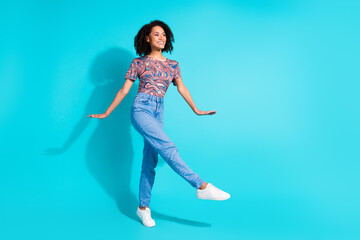 Full body photo of pretty young girl cute model look empty space step wear trendy colorful clothes isolated on aquamarine color background