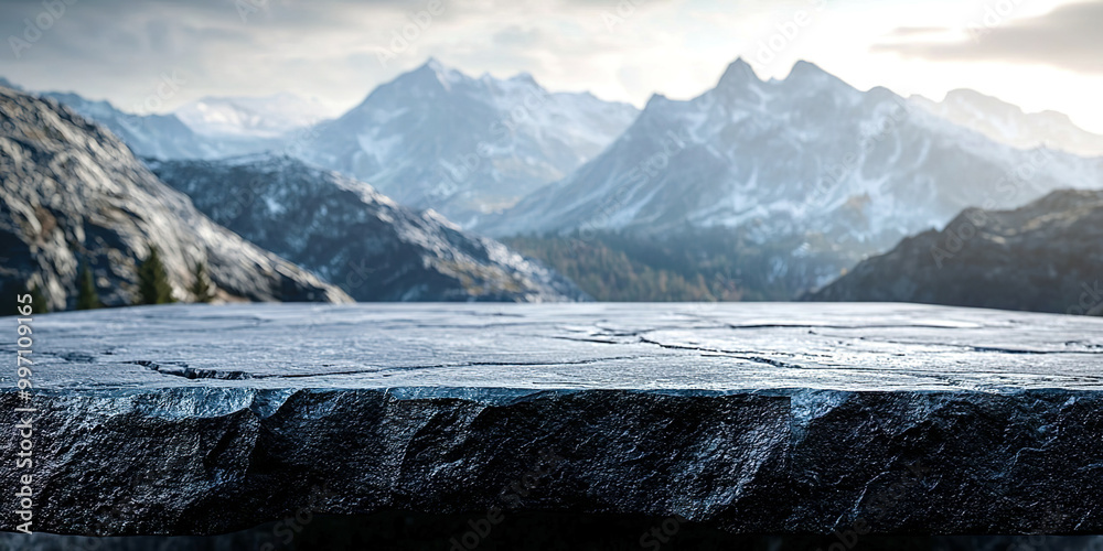 Poster a mountain range with snow on the peaks and a large rock in the foreground