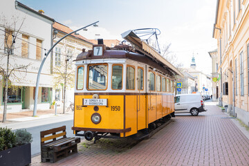 The Tram Caf&eacute; on a street in Szeged, Hungary, offers a unique dining experience inside a vintage tram car, blending nostalgia with modern urban life
