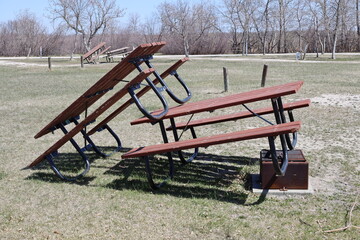 close up picnic tables stacked for winter storage to keep ice and snow off