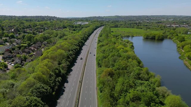 The drone aerial footage of A3 motorway and Riverside Park Nature Reserve in Guildford, England.  