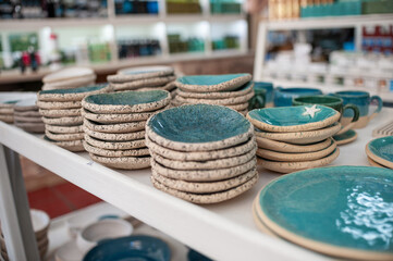 Many handmade souvenirs stacked on the shelf in Greek shop