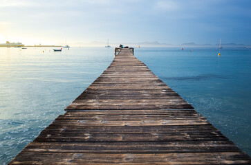 A wooden pier with a view of the ocean in Majorca