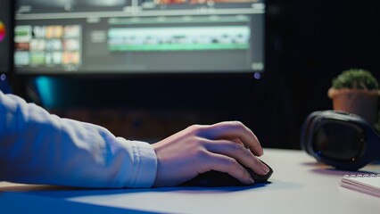 Extreme close up shot of video editor selecting key frames to use while doing video montage, working from home on computer. Woman using mouse to edit movie project footage in studio, camera B