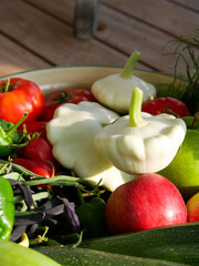 Harvest basket filled with fresh and ripe produce. Fruits and vegetable in the sun. Lying in a big bowl.