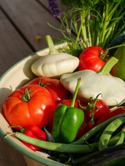 Harvest basket filled with fresh and ripe produce. Fruits and vegetable in the sun. Lying in a big bowl.
