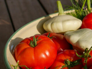 Harvest basket filled with fresh and ripe produce. Fruits and vegetable in the sun. Lying in a big bowl.