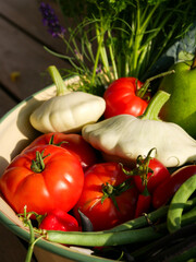 Harvest basket filled with fresh and ripe produce. Fruits and vegetable in the sun. Lying in a big bowl.