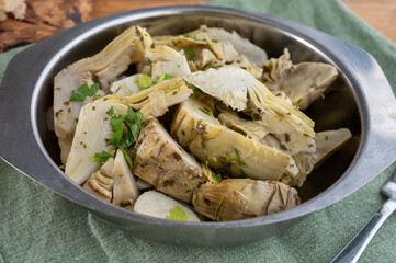 Italian food, pickled grilled artichokes hearts in olive oil close up