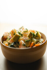A delicious bowl of shrimp and avocado is on the table