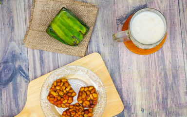 Village food menu consisting of a glass of milk, emping snacks and white sticky rice tape
