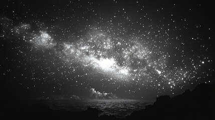 A black and white photo of a starry night sky with a large galaxy in the background.