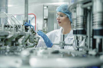 Day-to-day of quality control manager or female supervisors regularly inspect automated bottling...